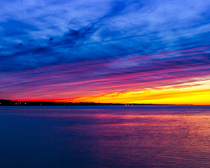 Lake Ontario Sunset from Irondequoit Bay Outlet by Clyde Comstock